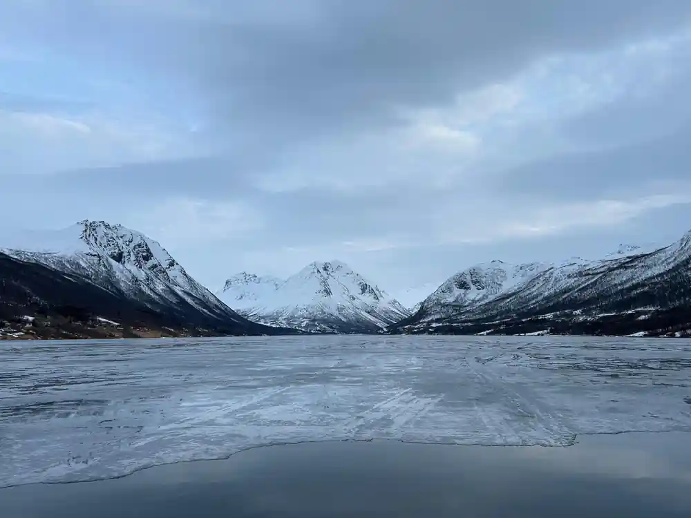 Frozen lake surrounded by snow-covered mountains