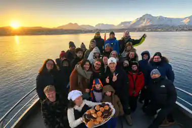 Large group holding platter of food outdoors on ice