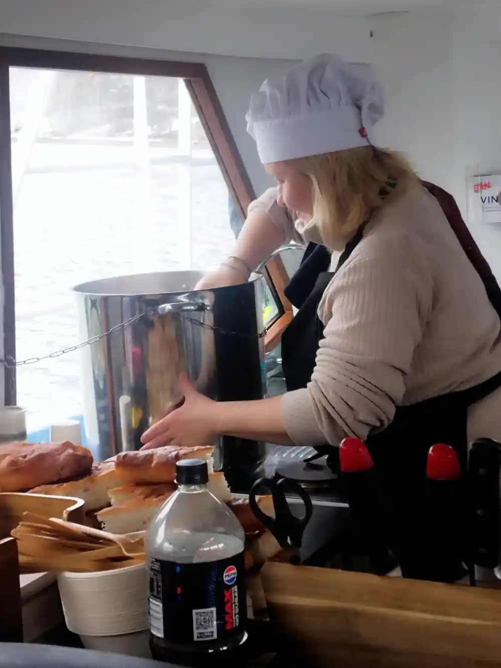 Woman in chef's hat preparing food in kitchen